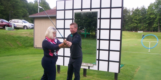 Joy gets her swing fined-tuned by Jason Guss, the Michigan PGAs Teacher-of-the-Year.